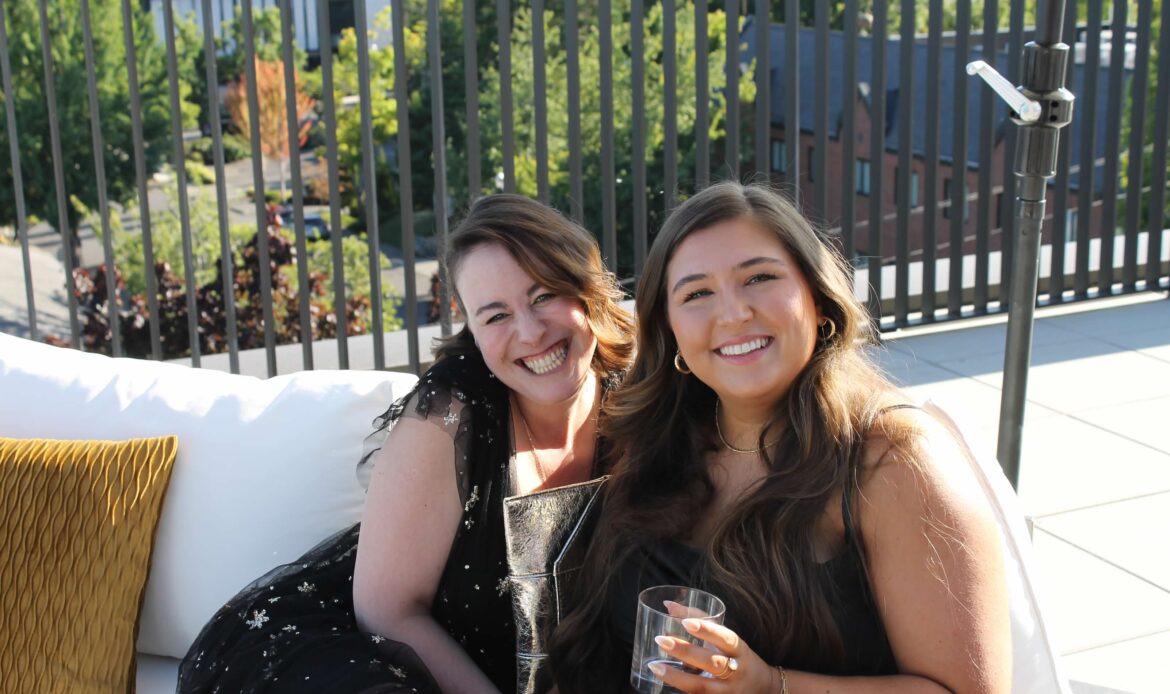 An image of two people smiling for the camera