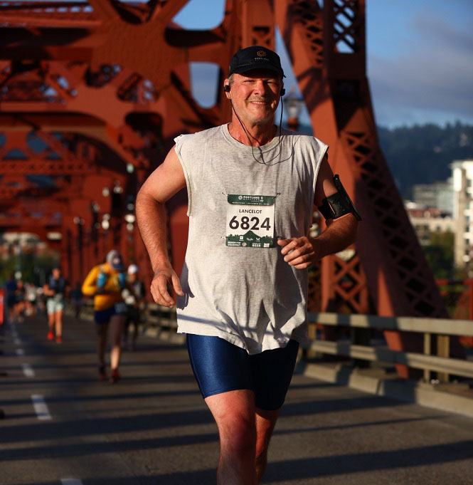 A man in marathon race with ear phone plugged in his ear