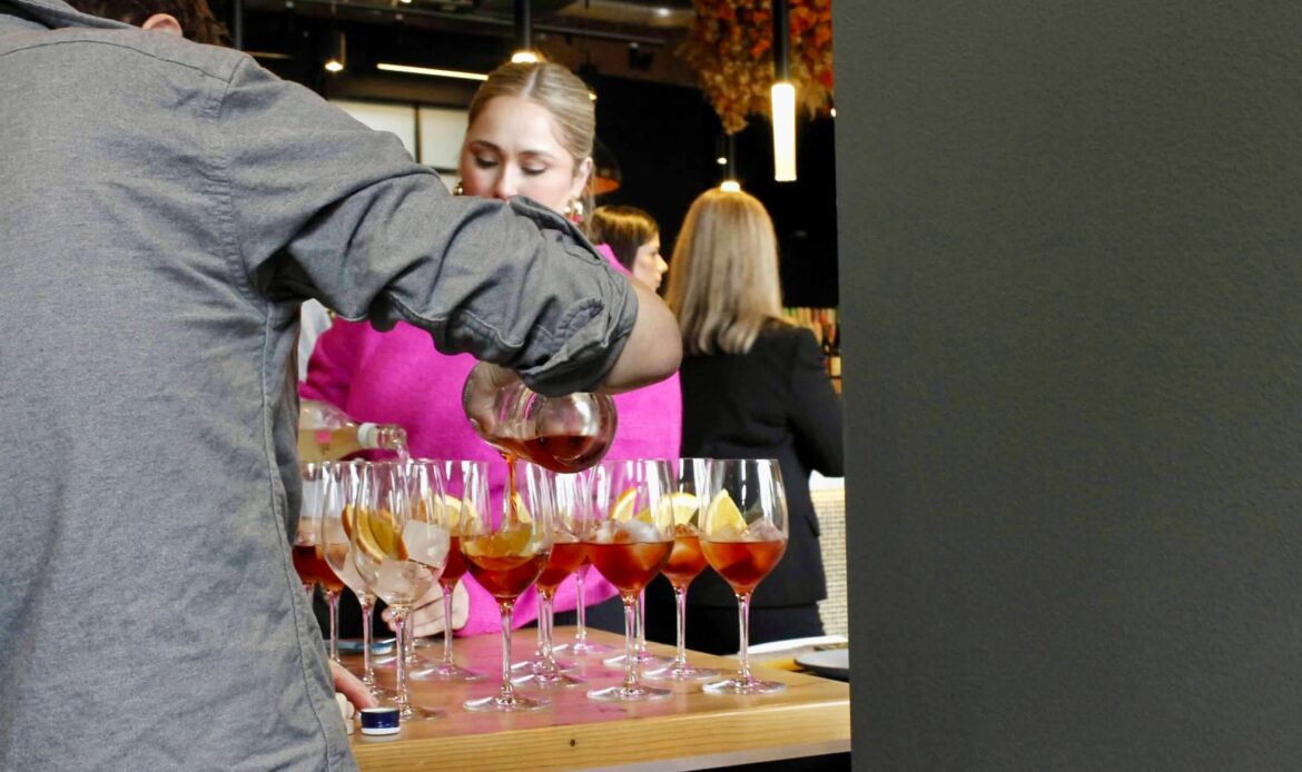 Image of person pouring wine for guests