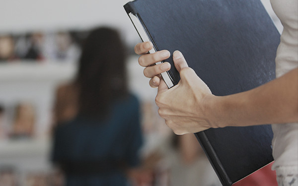 A CPA professional holding black file