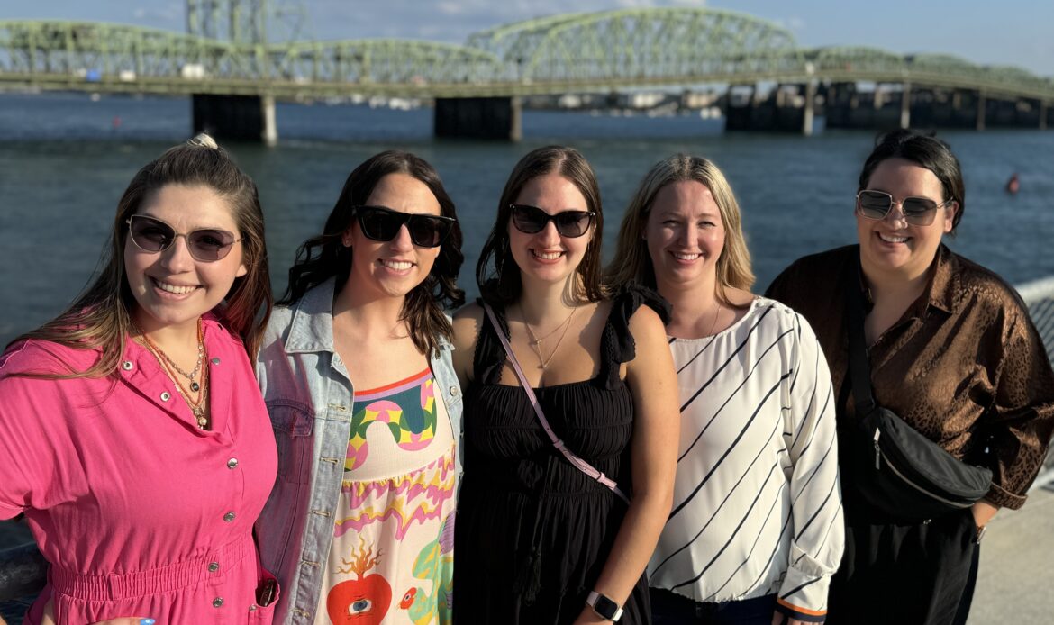 image of five women standing in the pier of the vancouver waterfront (Shelby Brooks, Shelby Shore, Ariel Bevier, Ariel Goldberg, Rebecca Kasten, Michele Stopper, Jordan Patterson)