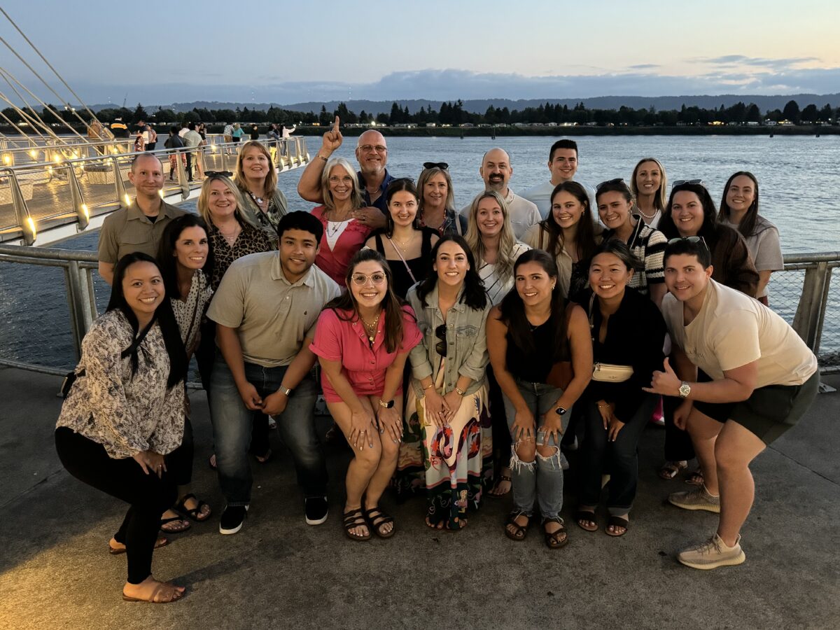 all company retreat photo on waterfront at sunset