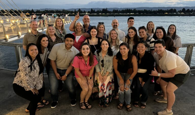 all company retreat photo on waterfront at sunset